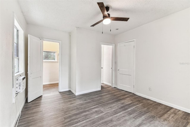 unfurnished bedroom with a textured ceiling, a closet, ceiling fan, and dark hardwood / wood-style flooring