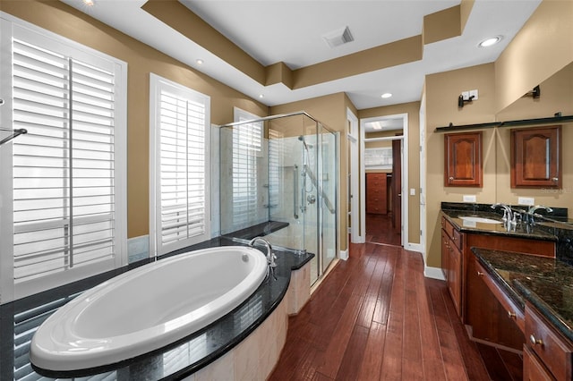 bathroom with independent shower and bath, hardwood / wood-style floors, and vanity