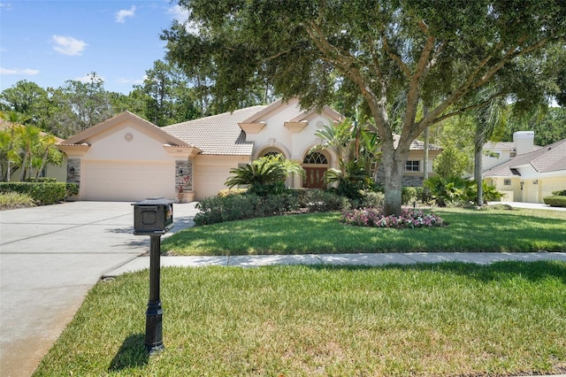 mediterranean / spanish house with a front lawn and a garage