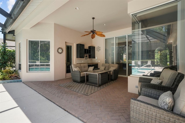 view of patio / terrace featuring ceiling fan and an outdoor living space