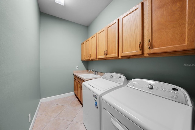 laundry room with independent washer and dryer, cabinets, light tile patterned flooring, and sink