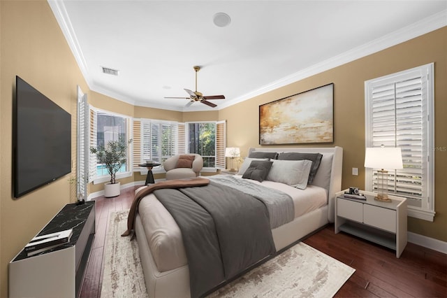 bedroom featuring ornamental molding, ceiling fan, and dark hardwood / wood-style floors