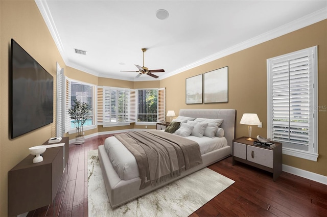 bedroom featuring ceiling fan, crown molding, and dark hardwood / wood-style floors