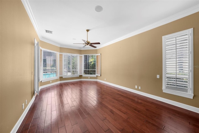 spare room with wood-type flooring, ceiling fan, and crown molding