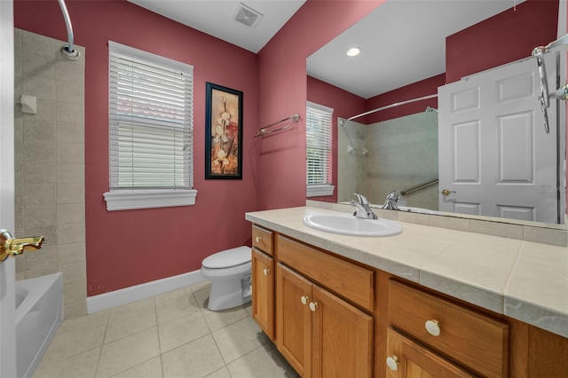 full bathroom featuring toilet, tile patterned flooring, a healthy amount of sunlight, and vanity