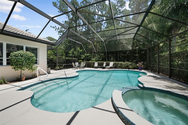 view of swimming pool with a lanai, an in ground hot tub, and a patio area