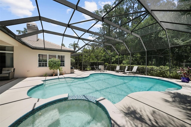 view of swimming pool with a lanai, an in ground hot tub, and a patio area