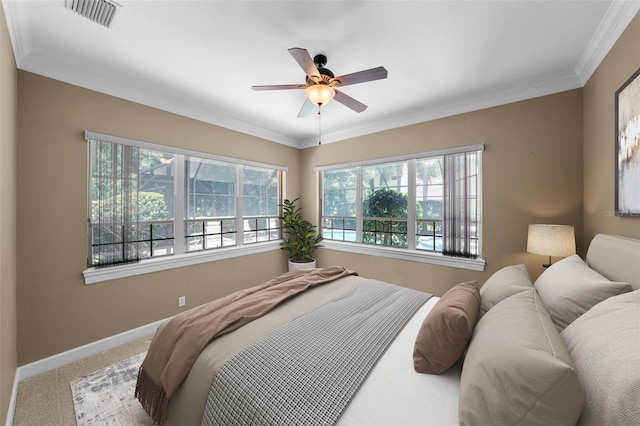 carpeted bedroom featuring ceiling fan and crown molding