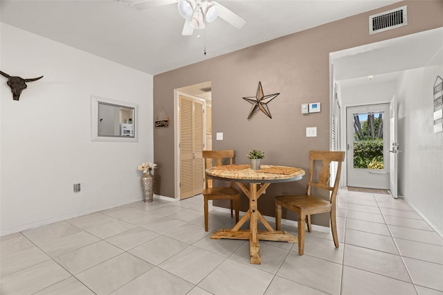 dining space featuring light tile patterned floors and ceiling fan