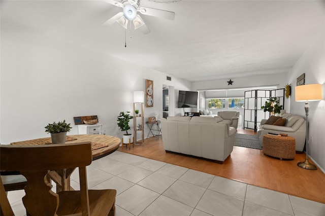 tiled living room featuring ceiling fan