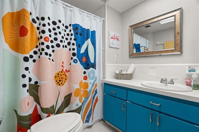 bathroom featuring vanity, curtained shower, and toilet