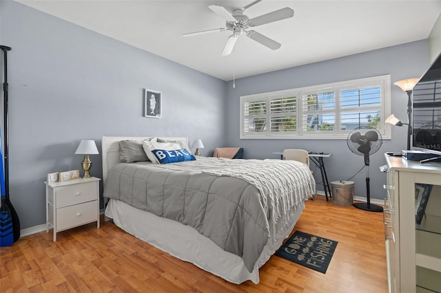 bedroom with multiple windows, ceiling fan, and light hardwood / wood-style flooring