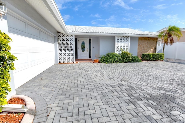 doorway to property with a garage