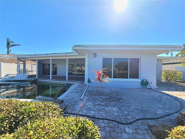 back of house featuring a patio area and a sunroom