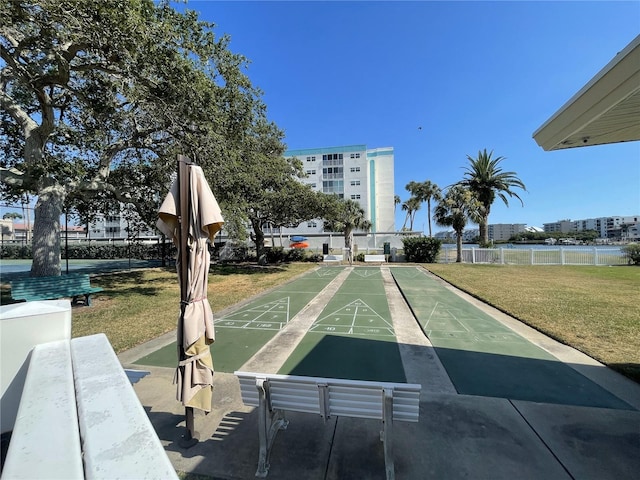 view of community featuring a lawn and a water view