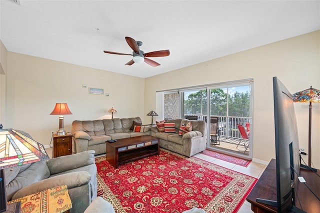 living room featuring ceiling fan and tile patterned floors