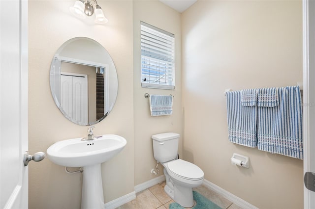 bathroom with toilet and tile patterned flooring