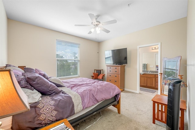 carpeted bedroom featuring ceiling fan and ensuite bath