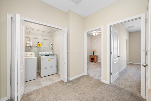 clothes washing area with light carpet, laundry area, visible vents, baseboards, and washing machine and dryer