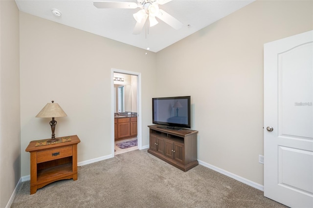 living area with light carpet and ceiling fan