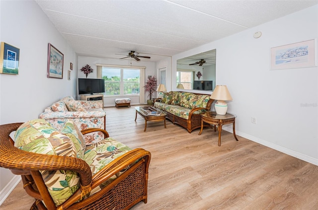 living room featuring light hardwood / wood-style floors and ceiling fan