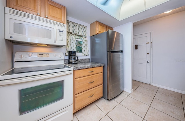 kitchen with white appliances and light tile patterned floors