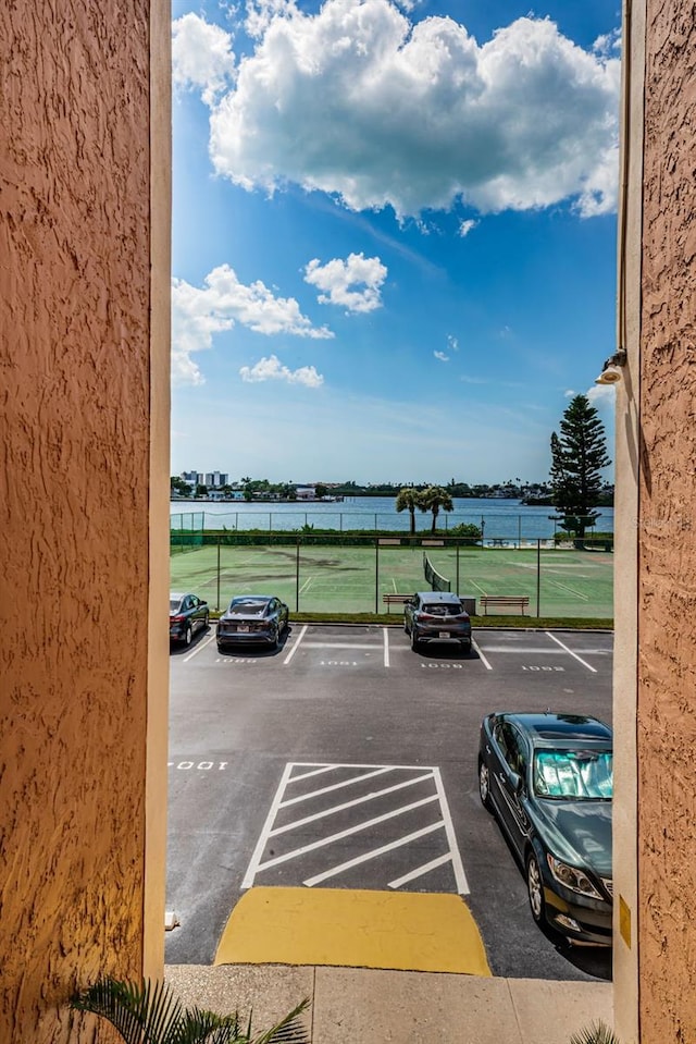 view of parking with a water view