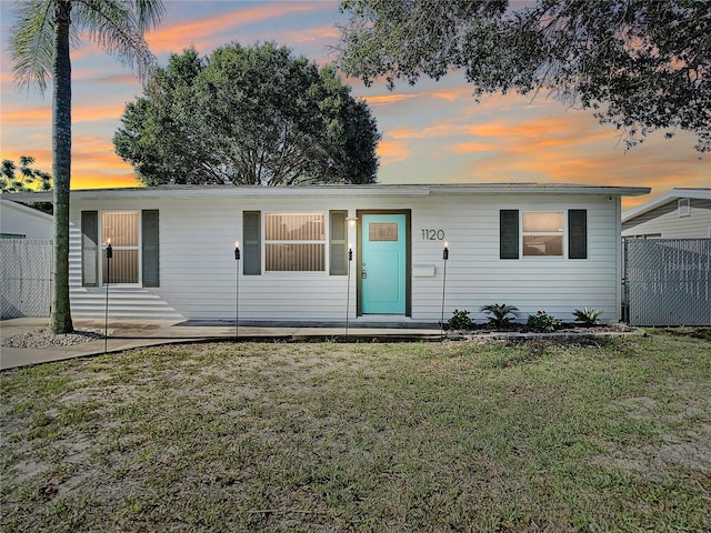 single story home featuring a yard