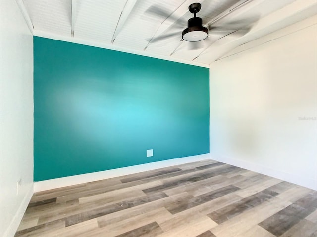 spare room with wood-type flooring