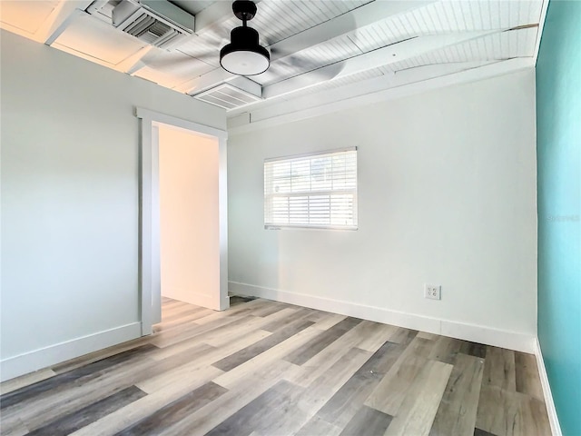 unfurnished room with light wood-type flooring and wood ceiling