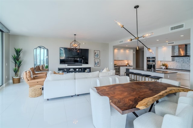 living room featuring light tile patterned floors and visible vents