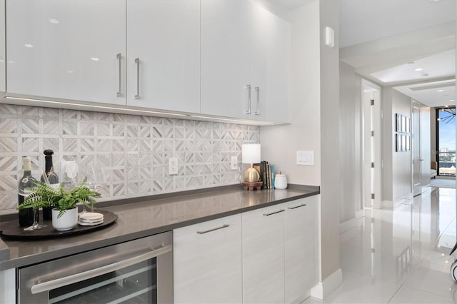 bar featuring beverage cooler, a dry bar, and decorative backsplash