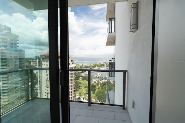 balcony featuring a water view and a view of city