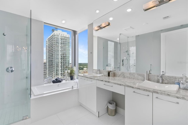 bathroom featuring a stall shower, a view of city, visible vents, and a sink