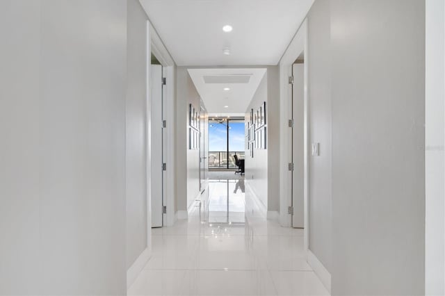 hallway with baseboards and recessed lighting