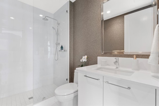 full bathroom with toilet, a shower stall, and vanity