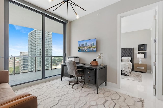 home office with baseboards, floor to ceiling windows, and a chandelier