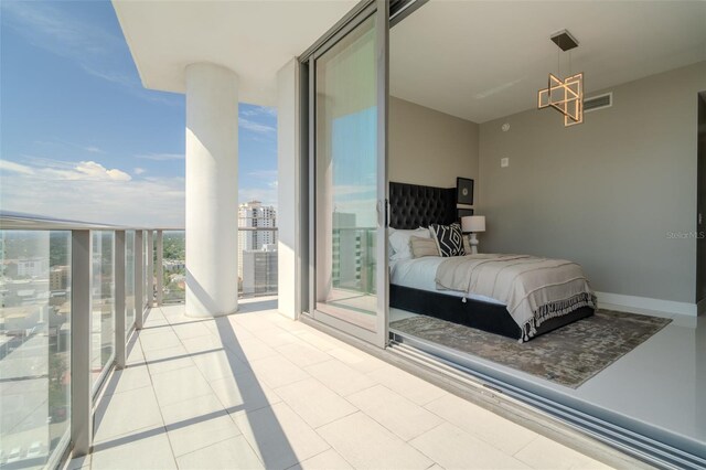 bedroom featuring expansive windows and light tile patterned floors