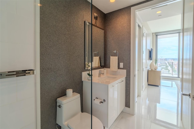 bathroom with vanity, tile patterned floors, floor to ceiling windows, and toilet