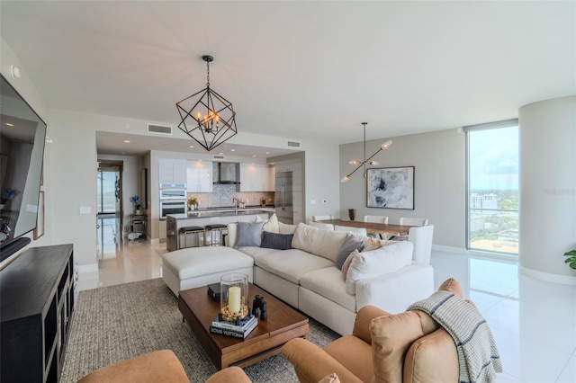 living area featuring expansive windows, visible vents, a notable chandelier, and recessed lighting