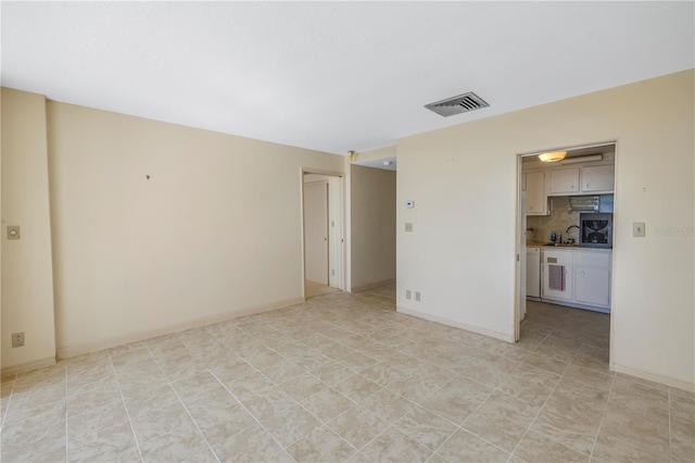 spare room with light tile patterned floors