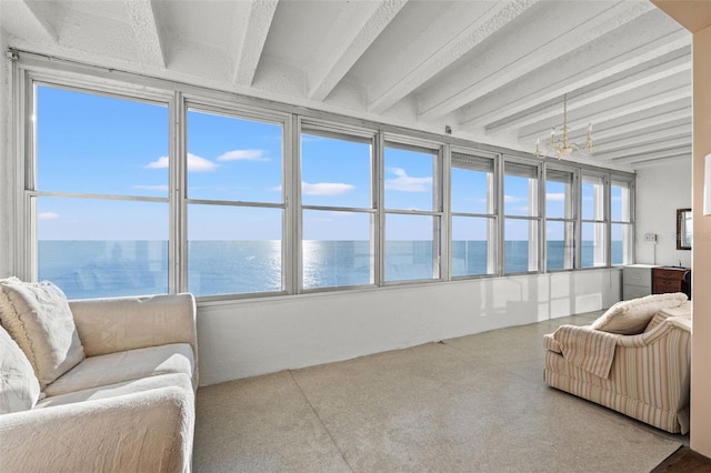 sunroom / solarium with beamed ceiling, a notable chandelier, and a water view