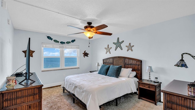 bedroom featuring a textured ceiling and ceiling fan