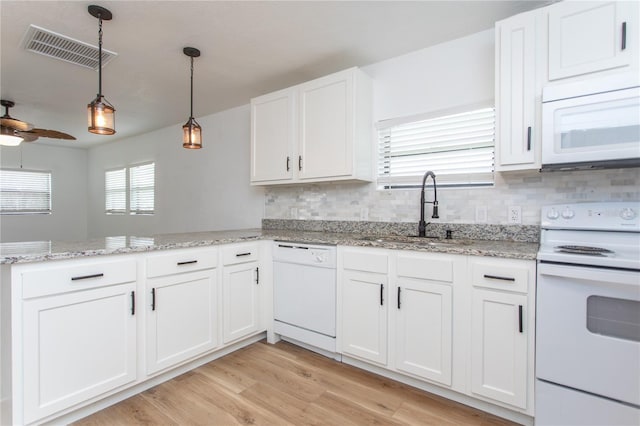 kitchen with kitchen peninsula, white appliances, sink, light hardwood / wood-style flooring, and white cabinetry