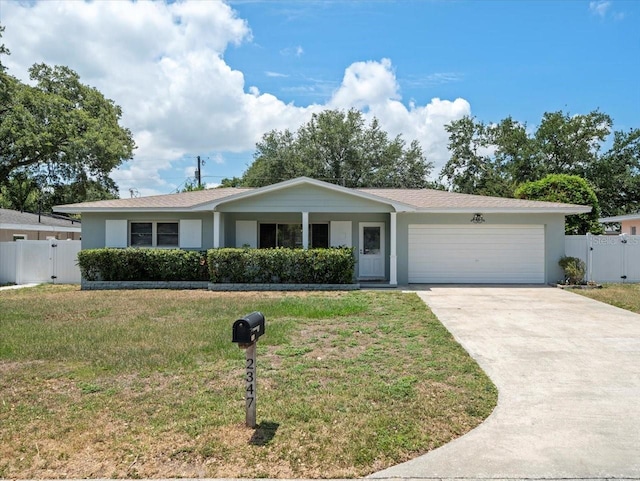 ranch-style house featuring a garage and a front lawn