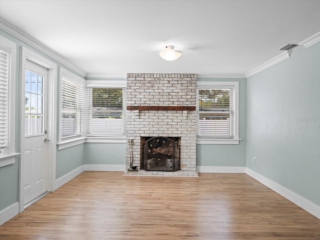 unfurnished living room featuring crown molding, a fireplace, and light hardwood / wood-style flooring