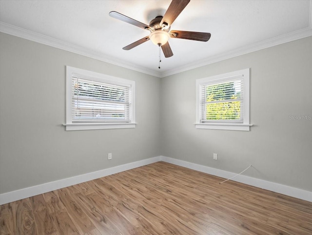 spare room featuring hardwood / wood-style flooring, ceiling fan, and ornamental molding