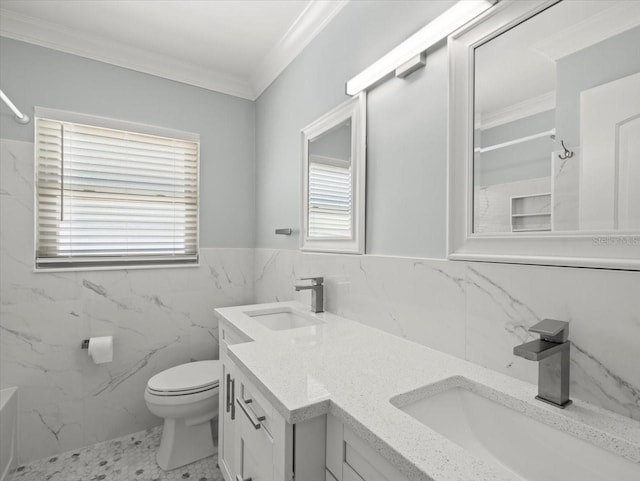 bathroom with ornamental molding, plenty of natural light, toilet, and vanity