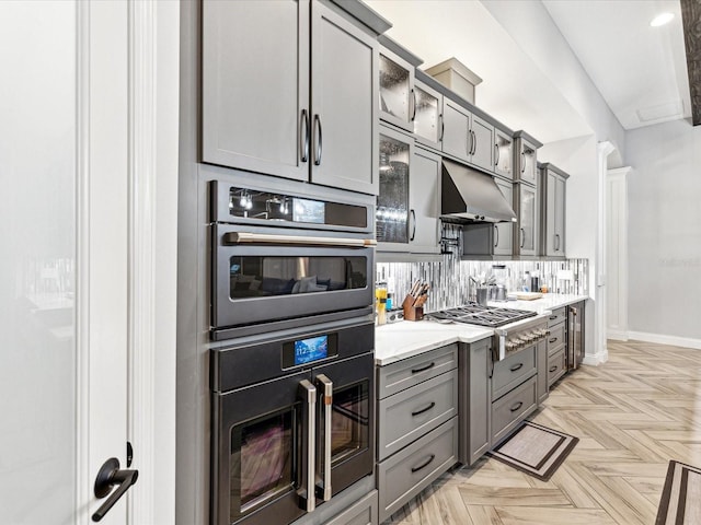 kitchen with gray cabinetry, appliances with stainless steel finishes, and light parquet floors