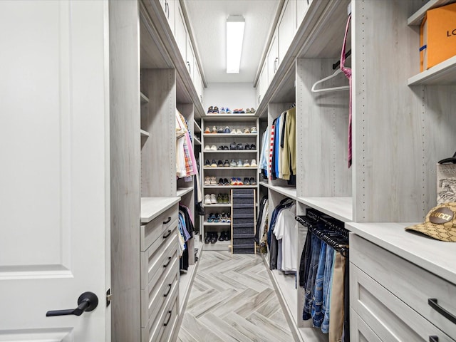 spacious closet with light parquet flooring